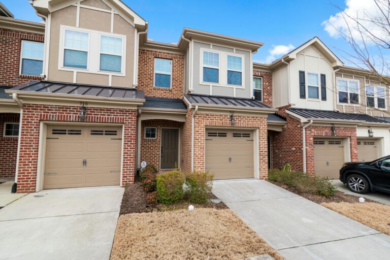Charming row of modern townhouses featuring brick facades and attached garages.